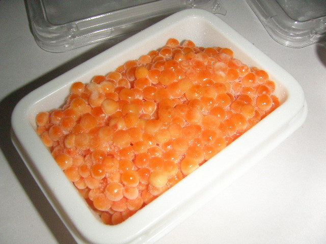 Salted ikura frozen in 100g tray, before lid and label applied